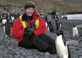 Becci Crowe with penguins in Antarctica